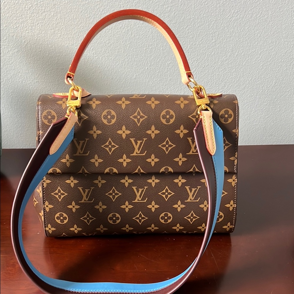 Louis Vuitton Cluny Top Handle Bag Monogram Canvas MM. Blue and Brown strap.